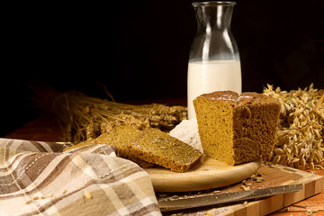 Wall Mural - Still life with a glass jug of milk, rye bread, ears of corn