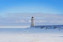 Lighthouse In A Calm And Desolate Winter Landscape.