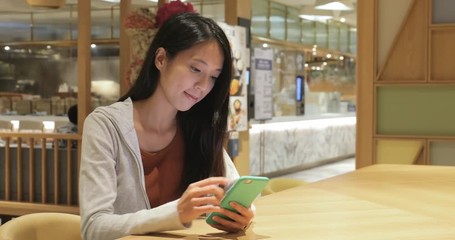 Poster - Woman use of mobile phone in coffee shop