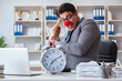 © Elnur - Clown businessman in the office with an axe and an alarm clock
