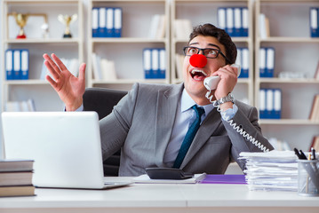 Clown businessman having fun in the office