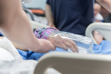 Patient in the hospital and holding a hand