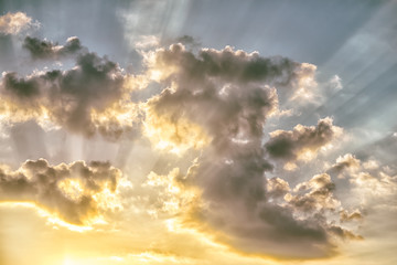 Wall Mural - colorful dramatic sky with clouds and sunbeams at sunset.