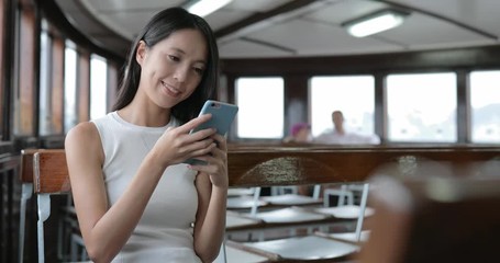 Canvas Print - Woman using app of smart phone and taking boat in Hong Kong city