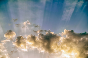Wall Mural - colorful dramatic sky with clouds and sunbeams at sunset.