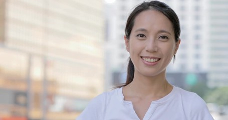 Wall Mural - Asian Woman smiling to the camera in the city