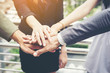 © Johnstocker - Close up of business people hands together. Teamwork concept.