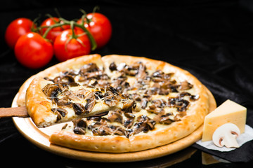 Sticker - selective focus on sliced piece of appetizing Italian cheese pizza with marinated mushrooms on the foreground, and whole pizza on the background