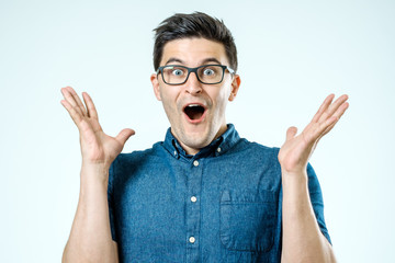 Portrait of young surprised man with opened mouth