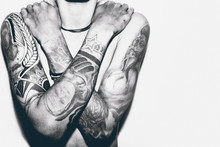 A Man Half Body Close Up Photo With Tattoo On The Both Arms

