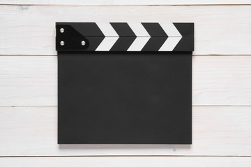 blank black clapper board on top view vintage white wood table for the action scene or filming and shooting movie or cinema production