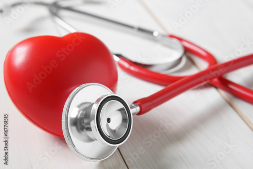 Fotomural closeup red heart rubber with stethoscope medical instrument on vintage white wo