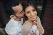 © VAKSMANV - beautiful wedding couple hugging standing near old building