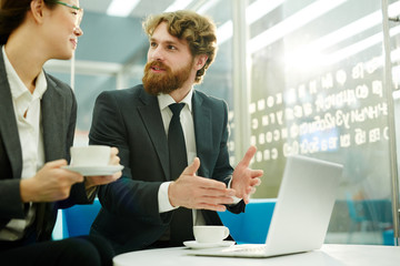 Sticker - Young economists discussing situation on stock market in office