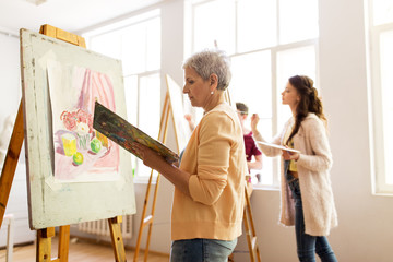 Sticker - woman artist with easel painting at art school