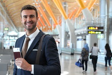 Handsome Businessman Smiling At The Airport With Space For Copy