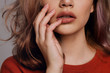 © Danil Nevsky/Stocksy - Sensual young woman touching lips with hand