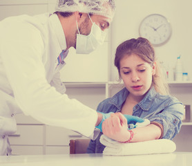 Doctor injecting teenage girl