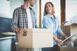 © lenets_tan - Couple unpacking cardboard boxes in their new home. Young couple.
