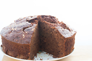 Sliced tasty homemade banana chocolate cake on table