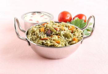 Wall Mural - Homemade rice pilaf, a popular and traditional Indian food, made from rice and vegetables like carrot, capsicum and peas, and yogurt tomato salad.