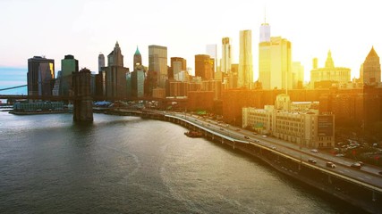 Wall Mural - New York, USA. Aerial view on the city skyline in New York City, USA during the sunset. Famous skyscrapers of the concrete jungle and car traffic. Brooklyn bridge