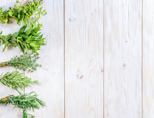 Wall Mural - Fresh herbs on the wooden table.