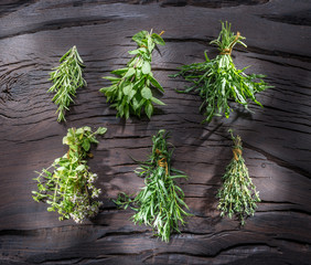 Wall Mural - Fresh herbs on the wooden table.