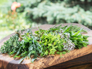 Wall Mural - Fresh herbs on the wooden table.