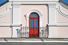 An Ancient Forging Balcony With An Arched Red Door. Grodno, Belarus.