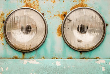 Pair Of Old Circle Retro Headlights On Grunge Rusty Metal Vehicle Body Closeup Concept Photo. Vintage Instagram Style Filtered