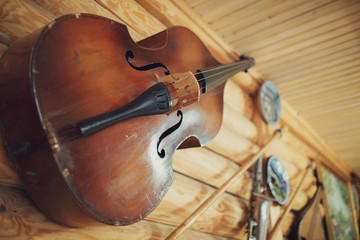 Old violin hangs under the roof