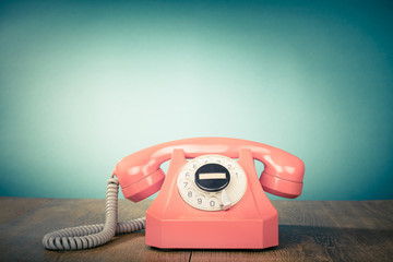 Fototapete - Retro old telephone on table front mint green background. Vintage style filtered photo