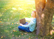 © lkoimages - Happy student study with laptop in city park