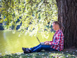 © lkoimages - Happy student study with laptop in city park