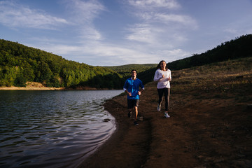Wall Mural - Couple jogging by the water