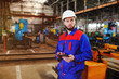 © Evgeniy Kalinovskiy - Portrait of a beautiful engineer in a construction helmet with a touch tablet on a factory background. male industrial technician working inside a factory