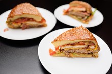 Appetizing Slices Of A Large Burger Or Meat Pie Closeup.On The Table In The Restaurant