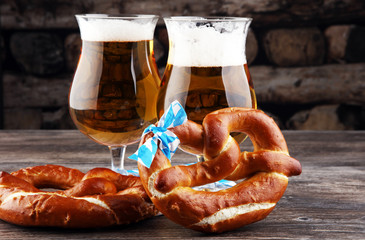 Original bavarian pretzels with beer on wooden board. Oktoberfest background