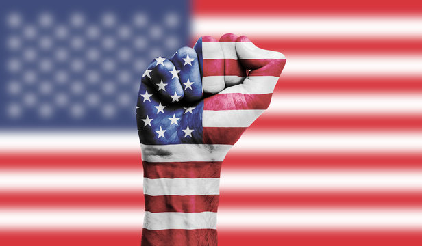 usa flag painted on a clenched fist. strength, power, protest concept