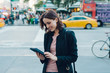 © Good Vibrations Images/Stocksy - Businesswoman in the city using a digital device