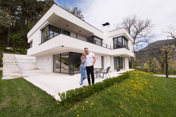 Wall Mural - couple hugging in front of  new luxury home