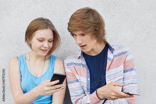 Teenage Girl With Trendy Hairstyle Wearing Blue Dress Holding Her