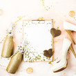Clipboard and Female shoes with golden decorations.  Flat lay, top view trendy holiday concept.