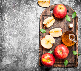 Sticker - Apple cider vinegar with fresh apples on cutting Board.