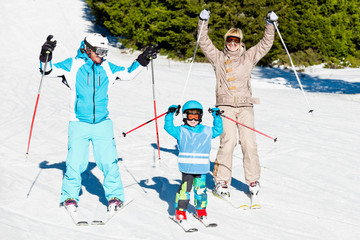 Wall Mural - Cheerful family skiing