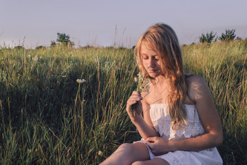 beautiful young girl in a summer field