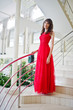 © AS Photo Family - Portrait of a beautiful girl in fashionable designer clothes posing on the fly of stairs in the hotel or in the restaurant.