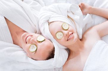 Positive delighted females doing face mask