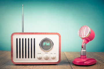 Poster - Retro wooden FM radio receiver, old microphone from 60s on table. Vintage style filtered photo